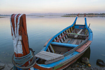 Wooden boat in Ubein Bridge at sunrise, Mandalay, Myanmar (World longest wooden bridge)