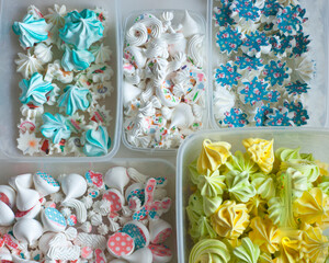 Industrial concept about food, mini colorful meringues in boxes for Confectionary decoration, horizontal, top view