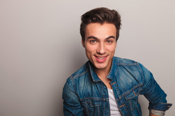 closeup portrait of a smiling young man in jeans jacket