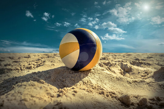 Beach Volleyball. Game ball under sunlight and blue sky.