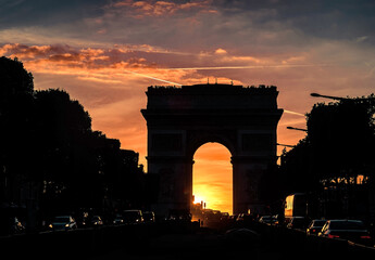 Fototapeta premium Arc de Triomphe in Paris under sunset sky with clouds. One of sy