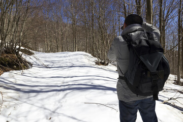 Fototapeta na wymiar hiker on mountain trail with snow in matese park
