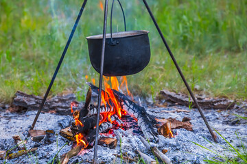touristic cauldron in a camp fire