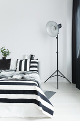 Bed with bedding and lamp