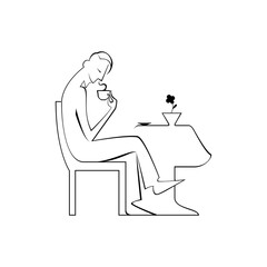 Fototapeta na wymiar Figura maschile beve il caffè seduto al tavolo