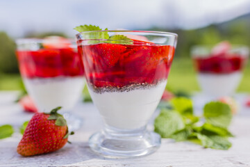 Yogurt with chia seeds and jelly and fresh strawberries.