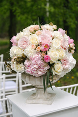 Beautiful wedding bouquet in stone vase, outdoors