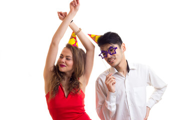 Young couple with card sticks and celebrating hats