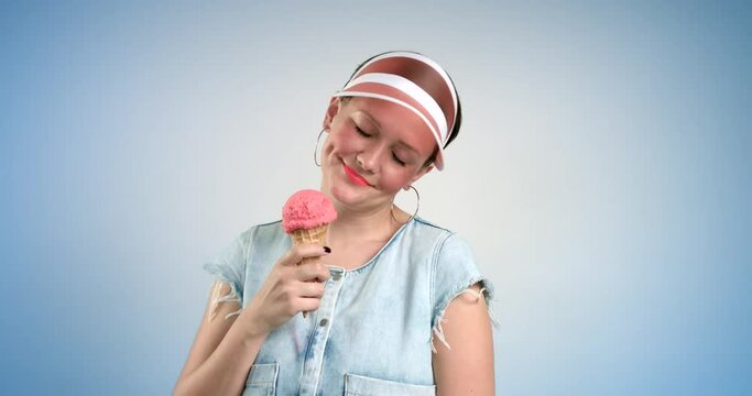 pretty woman in sun visor eats an ice cream