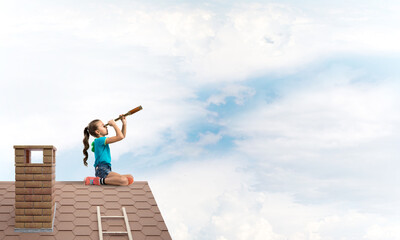 Concept of careless happy childhood with girl looking in spyglass