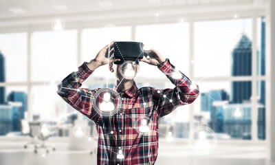 Guy wearing checked shirt and virtual mask demonstrating some em