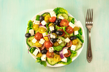Overhead photo of plate of Greek salad with copyspace
