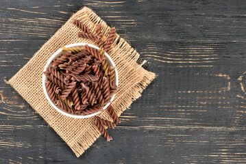 Dark fusilli pasta in bowl
