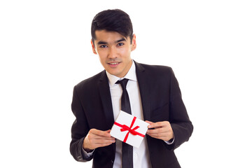 Young man in suit holding a present