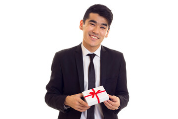 Young man in suit holding a present