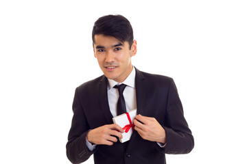 Young man in suit holding a present