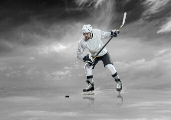 Fototapeta na wymiar Ice hockey player on the ice, outdoors 