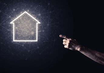 Conceptual image with hand pointing at house or main page icon o