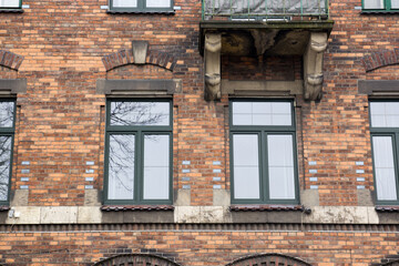 Vintage design windows with a balcony  on the facade of the old house