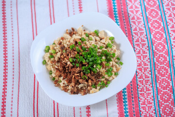 Chicken forcemeat with mushrooms and greens on a plate on a light background