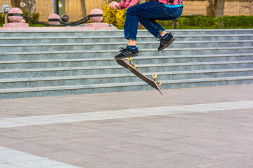 Close up skater does flip trick on skateboard