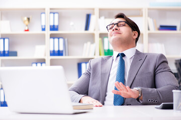 Businessman playing drums in office