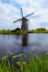 Traditional Dutch windmill on the canal bank in Kinderdijk Netherlands