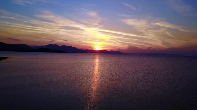 Aerial drone video of sunset over Drosia beach, Halkida, Evoia, Greece