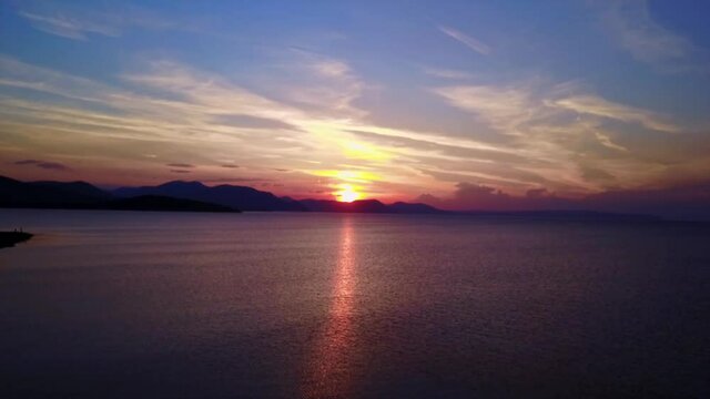 Aerial drone video of sunset over Drosia beach, Halkida, Evoia, Greece