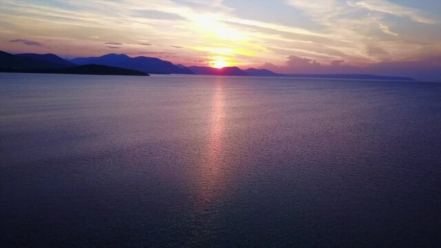 Aerial drone video of sunset over Drosia beach, Halkida, Evoia, Greece