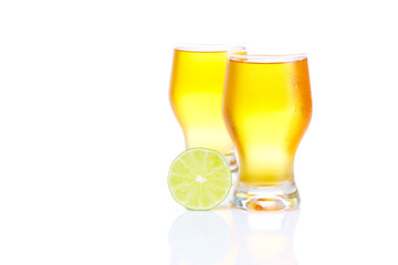A healthy diet and lifestyle concept:  Two yellow fruit juice with lime isolated on white. Closeup.
