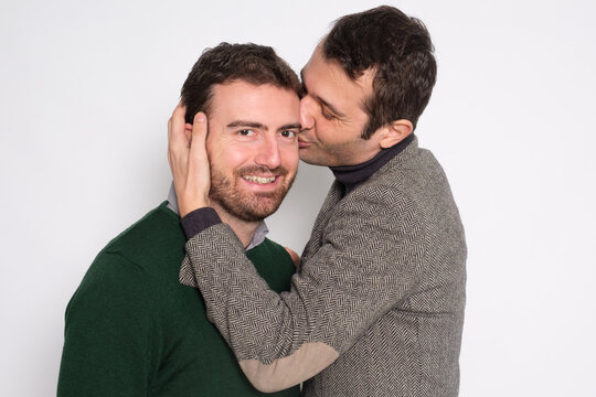 Portrait Of A Men Gay Couple In Studio Kissing Each Other