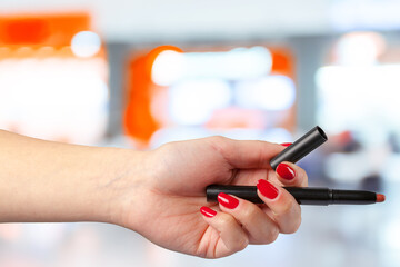 female hand holding a professional makeup brush