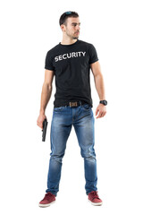 Confident macho plain clothes cop with gun looking away cautiously.  Full body length  portrait isolated on white studio background.