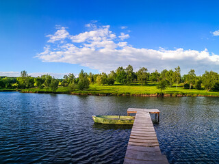 Obraz premium Background of nature landscape with clouds and lake with boat