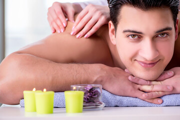 Obraz na płótnie Canvas Handsome man in spa massage concept