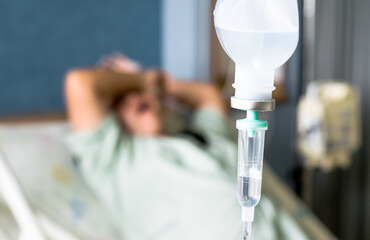 the saline IV drip over patient and Infusion pump in hospital