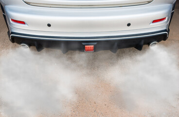 Car exhaust pipe comes out strongly of smoke, air pollution concept.