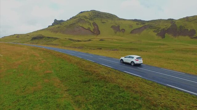 4K UHD Green dear in Iceland. Car in road
