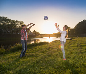 Naklejka premium Happy children jumping and playing with ball