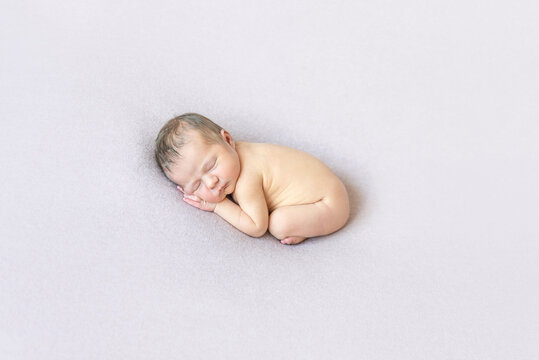 Naked Baby Sleeping On Belly, Curled Up