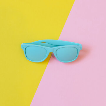 blue sunglasses for the summer for women and men. minimalist flat lay