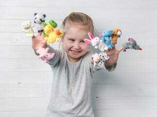 girl with doll puppets on her hands