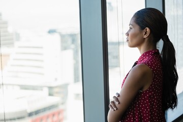 Thoughtful executive looking through window