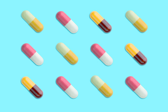 variety pills of capsules on blue background