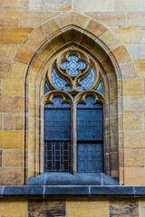 Fototapeta na wymiar The window in the Gothic style on the south facade of the Cathedral . Gothic Cathedral of Saints Vitus .Area of the Old Town of Prague, Czech Republic.
