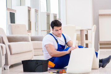 Furniture repairman working in store