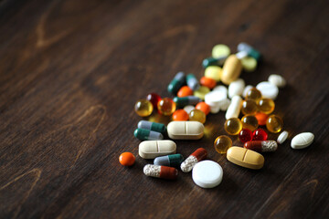 Medications and tablets on a wooden texture table