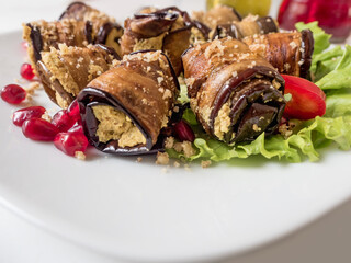 Eggplant rolls with walnuts. Delicious fried aubergines with nuts, herbs and pomegranate seeds. Dish of Georgian cuisine