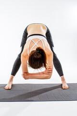 Sportswoman doing exercises on rug